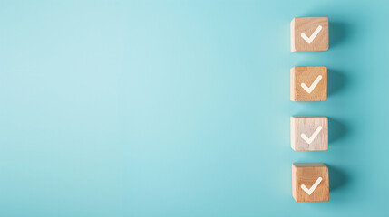 Obraz premium Wooden blocks with white checkmark icons stacked vertically against a soft blue background