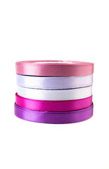 stack of satin ribbons in shades of purple against a white background