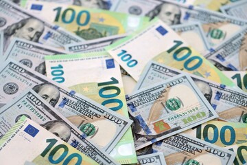 Obraz premium Big pile of Euro and USD banknotes. Many european and united states dollars