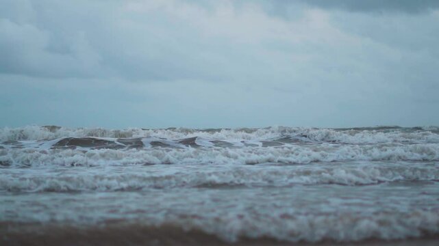 Beautiful sea waves at Mandvi beach in Kutch, Gujarat, India. Ocean waves crashing on shore during stormy weather. Water texture. Travel and holidays background. 
