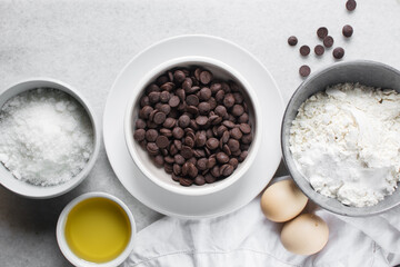 overhead view of mise en place for homemade chocolate chip cookies, ingredients for making chocolate chip cookies on a marble countertop