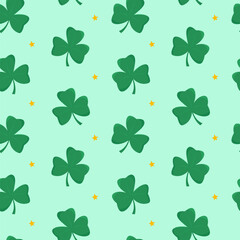 Green shamrocks and yellow stars arranged in a seamless pattern on a light green background. Symbol of luck and celebration