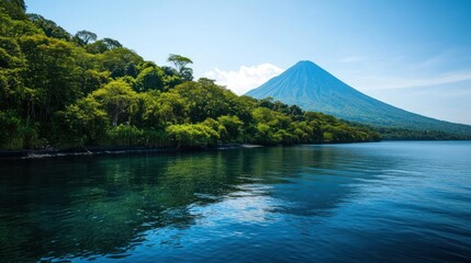 A Majestic View of a Volcano over Tranquil Waters Surrounded by Lush Green Forests