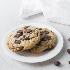 Overhead view of chocolate chip cookies on a white plate, top view of homemade chocolate chip cookies