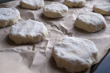 Culinary background with cookie cutter. Dough on baking paper.