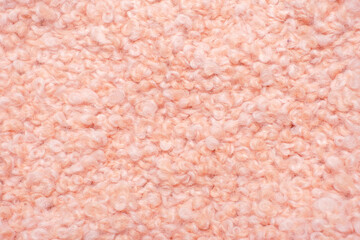Pink faux fur surface close-up, texture and background.
