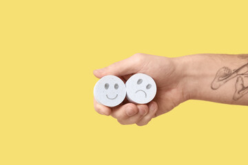 Man holding rating smiles on yellow background. Survey concept