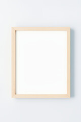 Blank picture frame on white wall background