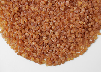 round pile of grainy brown sugar isolated on white transparent background. Brown sugar cubes arranged and isolated against a white backdrop. top view.