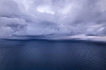 Heavy storm clouds gathering over the the ocean's surface