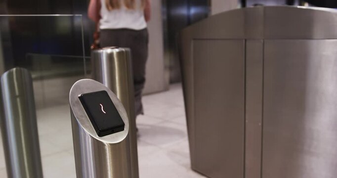 Using keycard for access, person entering office building through security gate