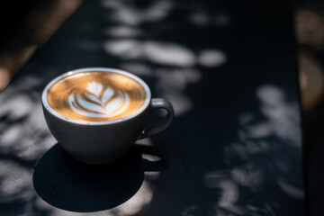 a cup of latte with a heart on it