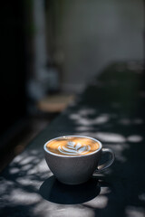 a cup of latte with a heart on it