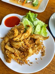 Crispy fried river fish in Thailand. Fried fish refers to any fish or shellfish that has been prepared by frying. Often, the fish is covered in batter, or flour, or herbs and spices before being fried