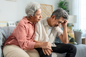 Obraz premium Asian elderly wife comforting upset husband crying with tears for problem.