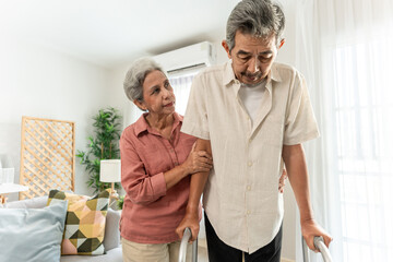 Obraz premium Asian attractive senior woman support elderly man walking with walker.