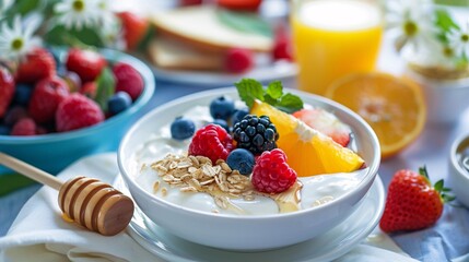 Delicious Greek yogurt breakfast with fruits, toast, honey, and a glass of orange juice
