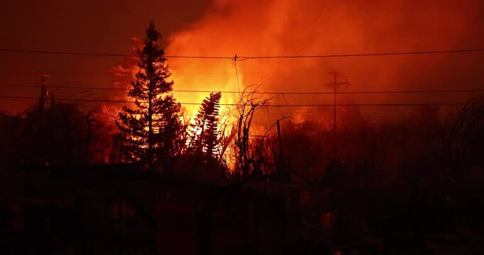 Altadena, California, USA - January 8, 2025: Powered by extreme Santa Ana winds, the Eaton Fire tears through a domestic neighborhood.