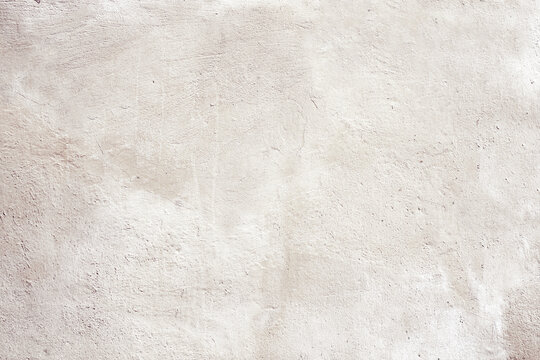 Grunge background with texture of stucco. Horizontal banner with old stucco wall texture of beige color. Mock up template. Copy space for text