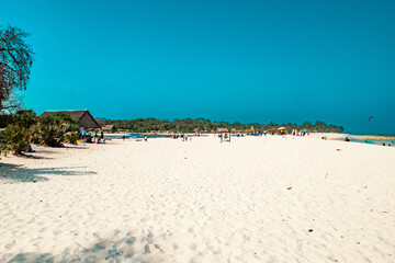 People having fun on the white sands of Tiwi Beach in Diani, Kenya 