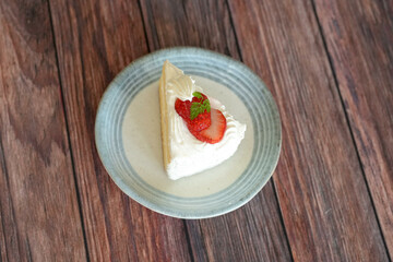Japanese shortcake with strawberries on top is placed on wooden floor