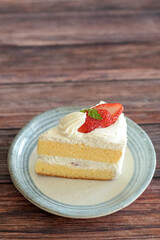 Japanese shortcake with strawberries on top is placed on wooden floor