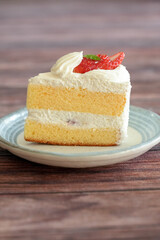 Japanese shortcake with strawberries on top is placed on wooden floor