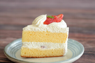 Japanese shortcake with strawberries on top is placed on wooden floor