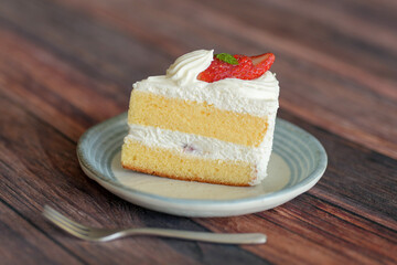 Japanese shortcake with strawberries on top is placed on wooden floor