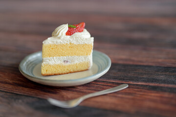 Japanese shortcake with strawberries on top is placed on wooden floor