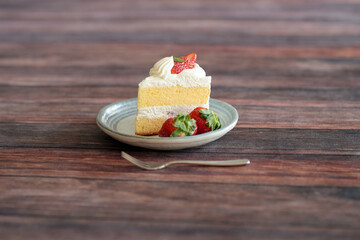 Japanese shortcake with strawberries on top is placed on wooden floor