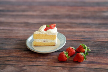 Japanese shortcake with strawberries on top is placed on wooden floor