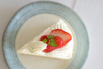 Japanese shortcake with strawberries on top is placed on a white wooden floor