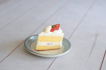 Japanese shortcake with strawberries on top is placed on a white wooden floor