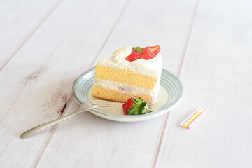 Japanese shortcake with strawberries on top is placed on a white wooden floor
