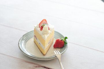 Japanese shortcake with strawberries on top is placed on a white wooden floor