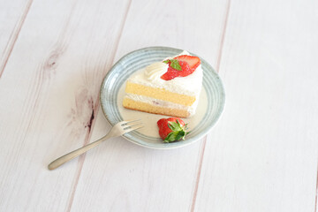 Japanese shortcake with strawberries on top is placed on a white wooden floor