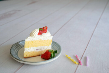 Japanese shortcake with strawberries on top is placed on a white wooden floor