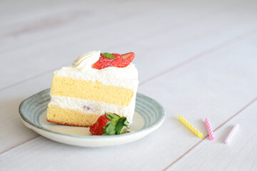 Japanese shortcake with strawberries on top is placed on a white wooden floor