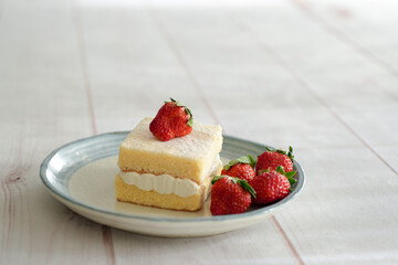 Japanese shortcake with strawberries on top is placed on a white wooden floor