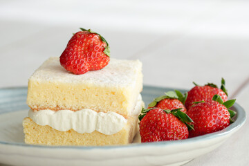 Japanese shortcake with strawberries on top is placed on a white wooden floor