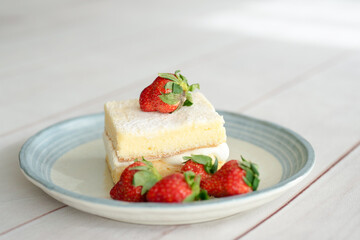 Japanese shortcake with strawberries on top is placed on a white wooden floor