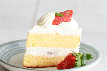 Japanese shortcake with strawberries on top is placed on a white wooden floor
