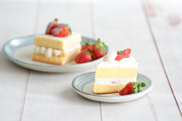 Japanese shortcake with strawberries on top is placed on a white wooden floor