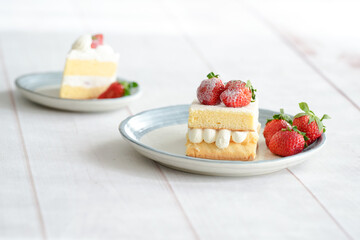 Japanese shortcake with strawberries on top is placed on a white wooden floor
