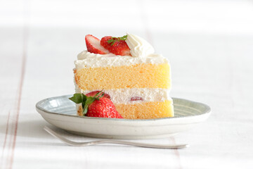 Japanese shortcake with strawberries on top is placed on a white wooden floor