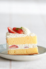 Japanese shortcake with strawberries on top is placed on a white wooden floor