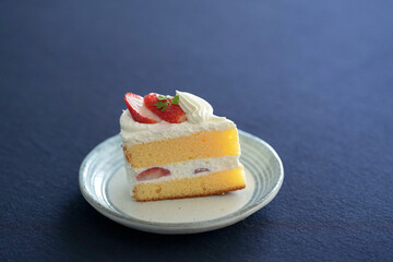 Japanese shortcake with strawberries on top is placed on a black cloth