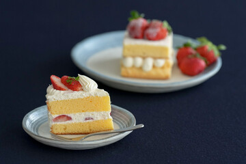 Japanese shortcake with strawberries on top is placed on a black cloth