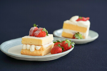 Japanese shortcake with strawberries on top is placed on a black cloth